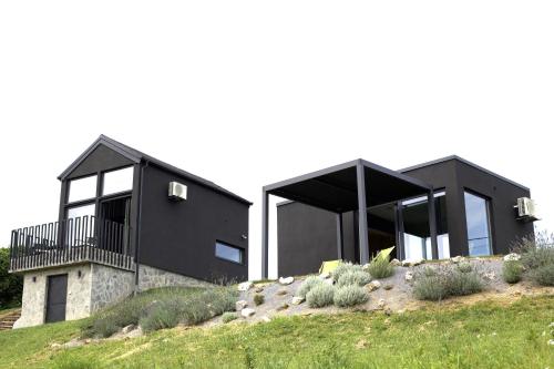 a black house on top of a hill at Wellness Villa Silente with spa area in Jalšovec