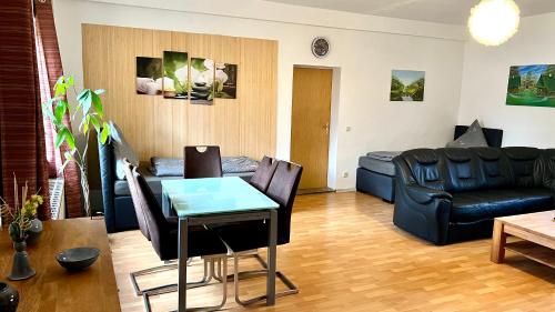 a living room with a couch and a table at Ferienwohnung Freund & Berndt in Nermsdorf