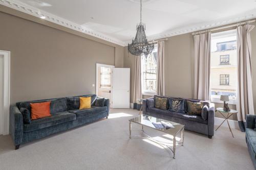 a living room with two couches and a table at Dream Stays Bath - Barton House in Bath