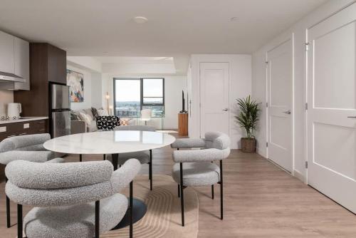 a kitchen and living room with a table and chairs at Upscale 1BR near MIT Harvard with Parking in Cambridge