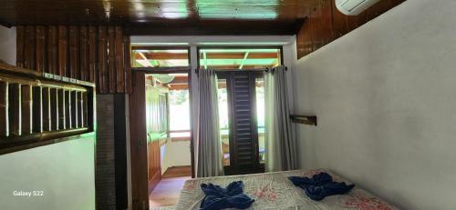 a bedroom with a bed with blue bows on it at Sam's Bungalows And Treks in Bukit Lawang
