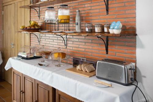 a kitchen with a counter with a toaster and a microwave at Passo do Lobo - Turismo Rural in Moura