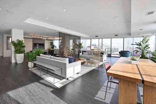a living room with a white couch and tables at Luxury Studio King bed Gym near MIT Harvard in Cambridge