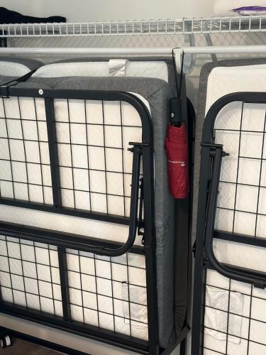 two bunk beds with a red fire extinguisher on them at Luxury Studio King bed Gym near MIT Harvard in Cambridge