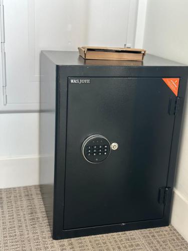 a black microwave oven sitting on top of a floor at Luxury Studio King bed Gym near MIT Harvard in Cambridge