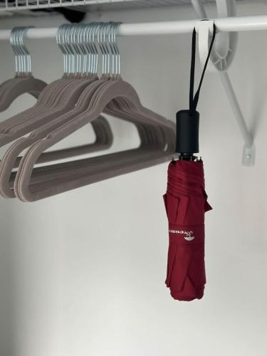 a red fire extinguisher hanging from a ceiling at Luxury Studio King bed Gym near MIT Harvard in Cambridge