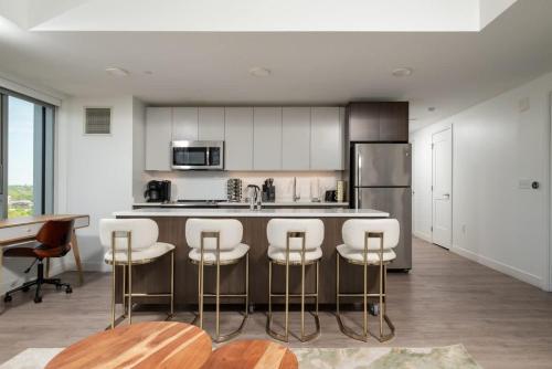 a kitchen with a bar with stools and a table at Central Serene Condo King Bed by MIT Harvard GYM in Cambridge