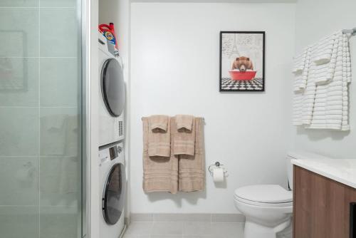 a white bathroom with a toilet and a shower at Lux Studio 2xQueen beds Gym near MIT Harvard in Cambridge
