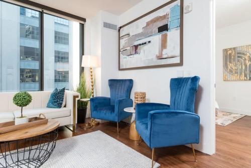 a living room with blue chairs and a couch at Back-Bay Upscale Central Condo Bos Common Downtown in Boston