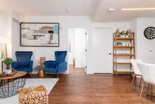 a living room with blue chairs and a table at Back-Bay Upscale Central Condo Bos Common Downtown in Boston