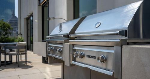 a row of bbq equipment on the side of a building at Back-Bay Upscale Central Condo Bos Common Downtown in Boston