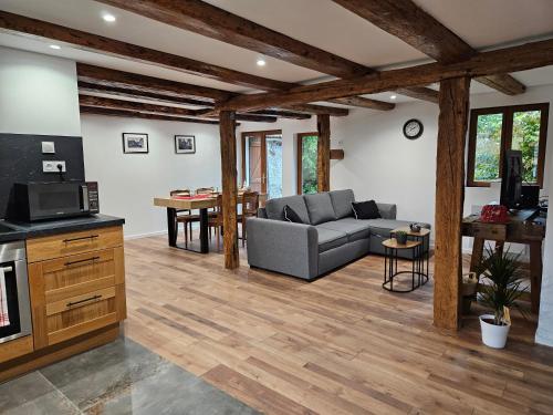 a living room with a couch and a table at Gite à la fontaine in Bergholtz-Zell