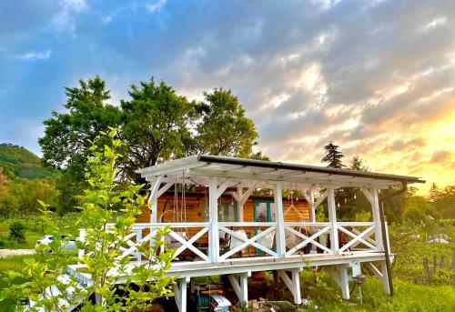 a small house with a porch in a field at Bohemian ECO lodge in Kisapáti