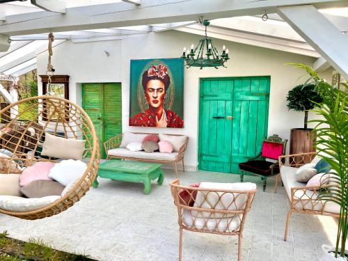 a patio with chairs and a painting of a woman at Bohemian ECO lodge in Kisapáti