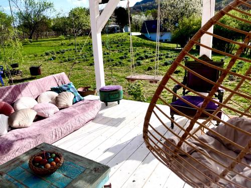 a living room with a couch and a swing at Bohemian ECO lodge in Kisapáti