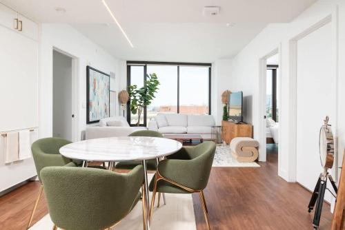 a living room with a table and chairs at Back-Bay Upscale Central Penthouse W Roof-top in Boston