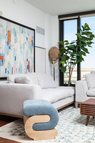 a living room with two white couches and a blue stool at Back-Bay Upscale Central Penthouse W Roof-top in Boston