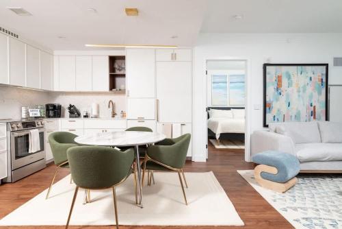 a kitchen and living room with a table and chairs at Back-Bay Upscale Central Penthouse W Roof-top in Boston