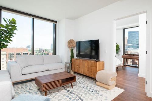 a living room with a couch and a tv at Back-Bay Upscale Central Penthouse W Roof-top in Boston