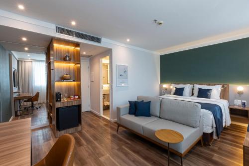 a hotel room with a bed and a couch at Blue Tree Premium Faria Lima in Sao Paulo