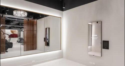 a room with mirrors on the wall and a room with a chair at Back-Bay Upscale Central Penthouse W Roof-top in Boston