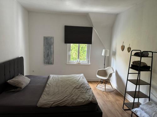 a bedroom with a bed and a ladder and a window at Zentral gelegene 3 Zimmerwohnung mit zwei Schlafzimmern ideal für Monteure in Bad Oeynhausen