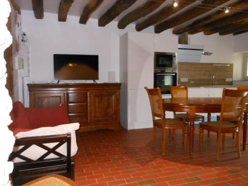 a kitchen and dining room with a table and chairs at Gîte familial près de Chartres avec jardin privatif et wifi - FR-1-581-141 in Saint-Symphorien