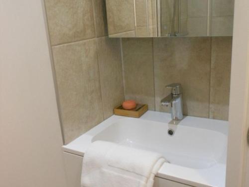 a bathroom with a sink with a faucet at Gîte familial près de Chartres avec jardin privatif et wifi - FR-1-581-141 in Saint-Symphorien