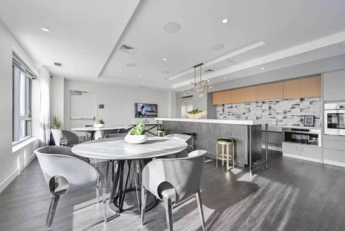 a kitchen and dining room with a table and chairs at Central Square Penthouse near MIT Harvard Wi-Fi & GYM in Cambridge