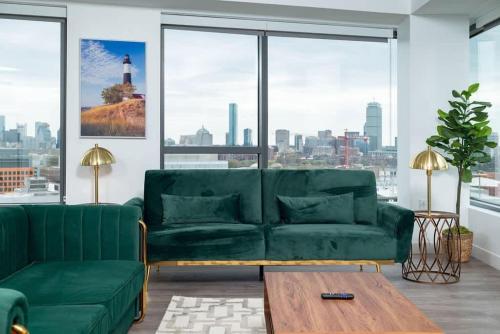 a living room with a green couch and a table at Central Square Penthouse near MIT Harvard Wi-Fi & GYM in Cambridge