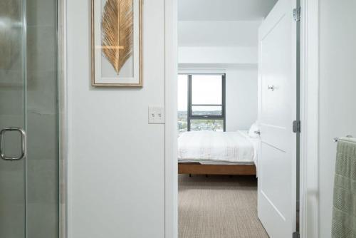 a bathroom with a door leading to a bedroom at Central Square Penthouse near MIT Harvard Wi-Fi & GYM in Cambridge