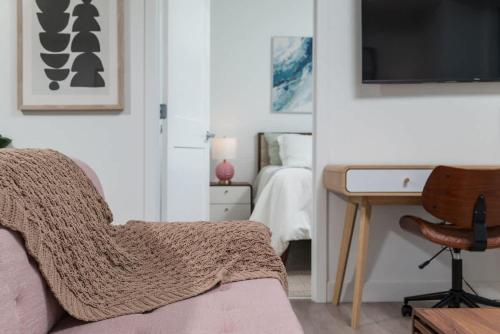 a bedroom with a bed and a desk with a chair at Upscale Penthouse near MIT Harvard Central Square in Cambridge