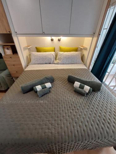 a large bed with two pillows on it in a room at Buenas Flores Tenerife in Costa Del Silencio
