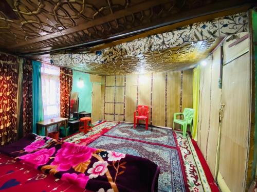 a bedroom with a bed and a table and chairs at Island hotel and homestay in Srinagar