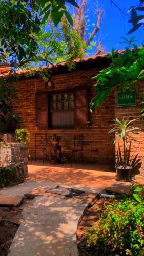 a brick building with a sign in front of it at LUMA - Casa de Hospedaria in São Roque