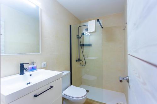 a bathroom with a toilet and a sink and a shower at Azul Zahara in Zahara de los Atunes