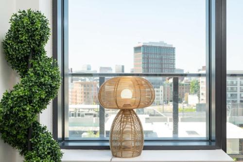 a wicker lamp sitting on a window sill at Luxury Apartment w King Bed Shared Pool & Rooftop in Cambridge