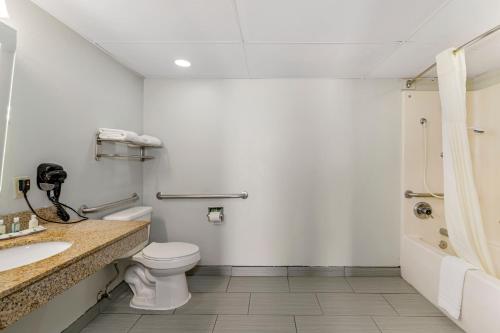 a bathroom with a toilet and a sink and a shower at Quality Inn Siloam Springs West in Siloam Springs