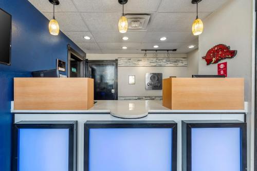 a waiting room with a table and two doors at Quality Inn Siloam Springs West in Siloam Springs