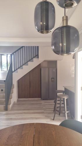 a dining room with stairs and a table and chairs at Tranquility villas in Baie Sainte Anne