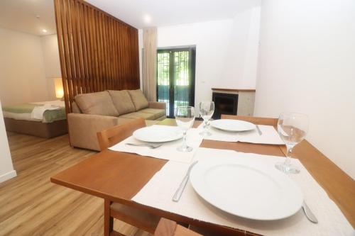 a dining room with a table with wine glasses at Quinta das Varcandas Gerês - Apartamento 2 by Gerês Casas in Geres