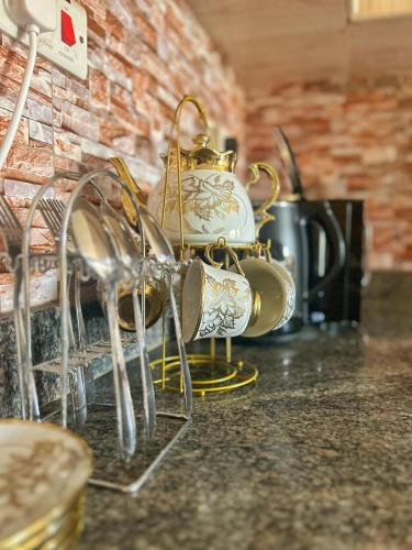 a pile of tea pots and pans on a counter at EBEL Homes in Kampala