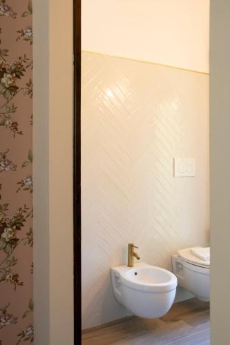a bathroom with a sink and a toilet at L’Aurora in Todi