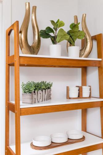 a wooden shelf with plants and plates on it at Back-Bay Upscale Central Condo Bos Common Downtown in Boston