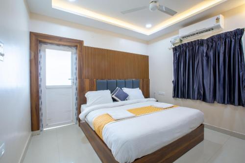a bedroom with a large bed and a window at Sruthi Residency in Rāmeswaram