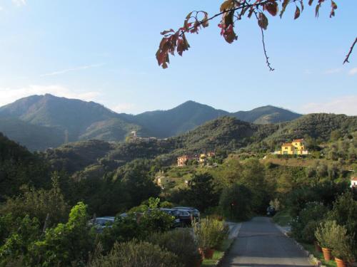 a mountain road with cars parked on the road at Villanova Apartments - Nature & Wellness in Levanto