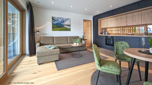 a living room with a couch and a table at Seehaus am Kochelsee in Kochel
