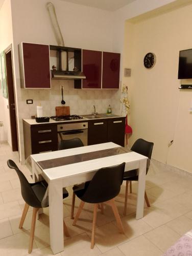 a kitchen with a table and chairs in a room at La casa nella Valle in Monti di Licciana Nardi