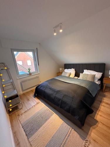a bedroom with a large bed and a window at Harlehaus Nina in Friedrichsschleuse
