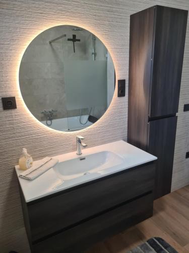 a bathroom with a sink and a mirror at Ferienhaus am Berg in Hohenfels-Essingen